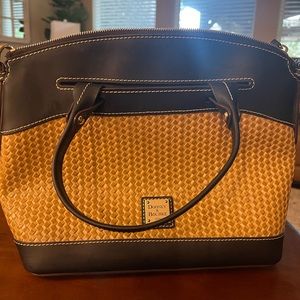 Beautiful Dooney Bourke bag in black and straw colors. Interior is blue ticking.